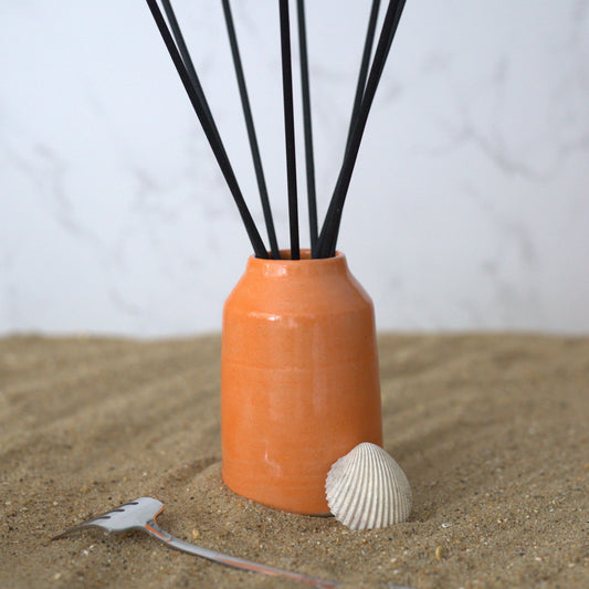 Orange Mandarin Reed Diffuser by Katie L Thompson Designs with square glass bottle and natural reed sticks for fresh scent.