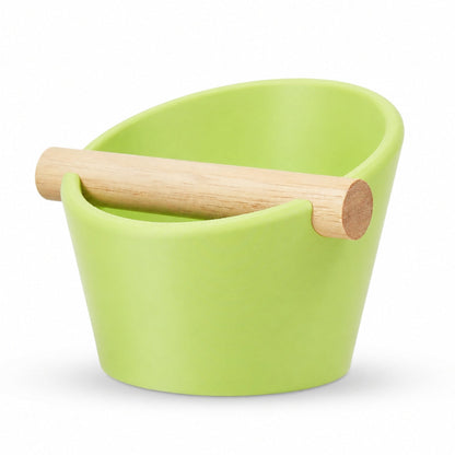 Oval KNOCDIC® coffee knock box with real oak wood bar in apple green, designed for espresso shot pucks and coffee grounds.