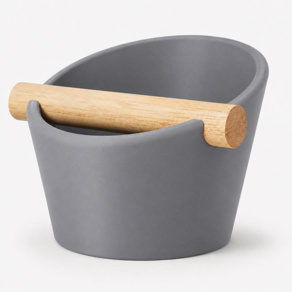 Oval coffee knock box with real oak wood bar by KNOCDIC® in ash grey, featuring a sturdy oval design for espresso puck disposal.