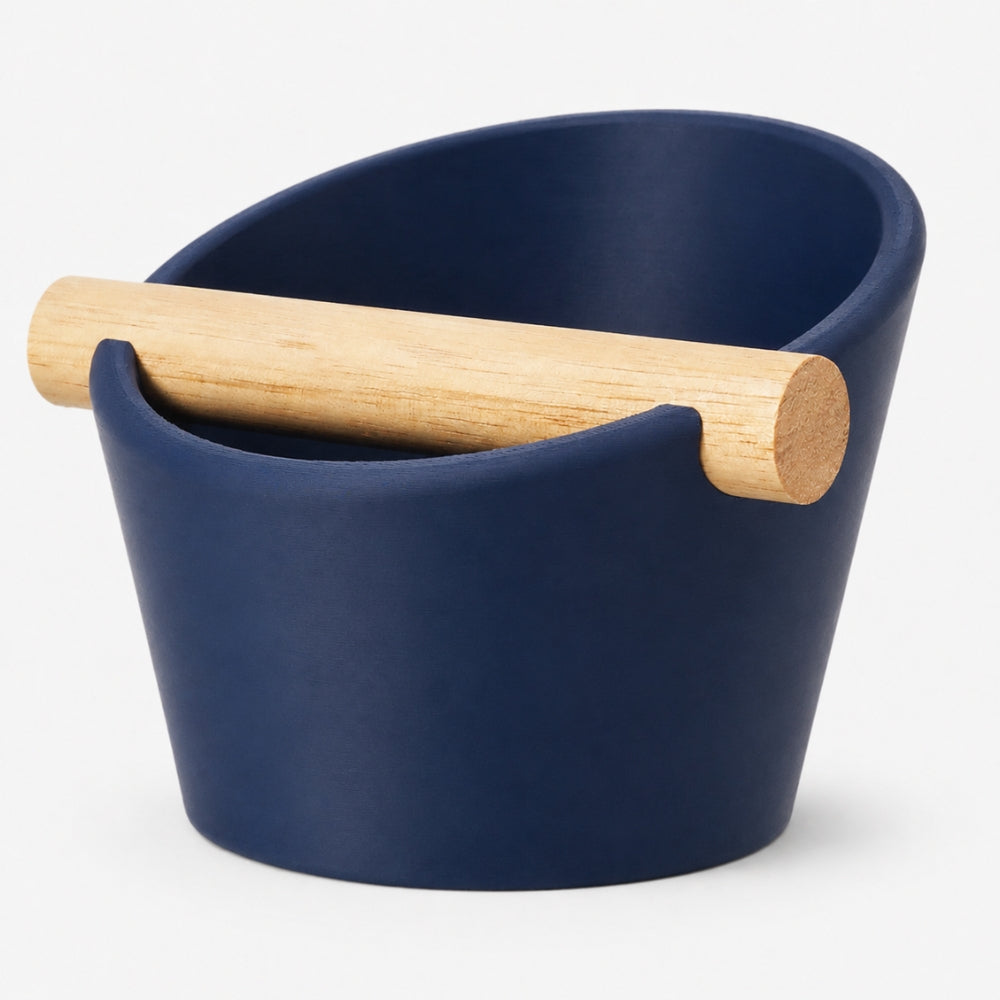 Dark blue oval coffee knock box with real oak wood bar by KNOCDIC® for espresso machine waste disposal.