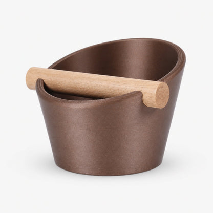 Oval coffee knock box by KNOCDIC® with a real oak wood bar, featuring a galaxy brown finish for espresso machine cleanup.