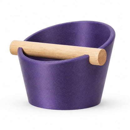 Oval KNOCDIC® coffee knock box with galaxy purple finish and real oak wood bar for espresso grounds disposal.