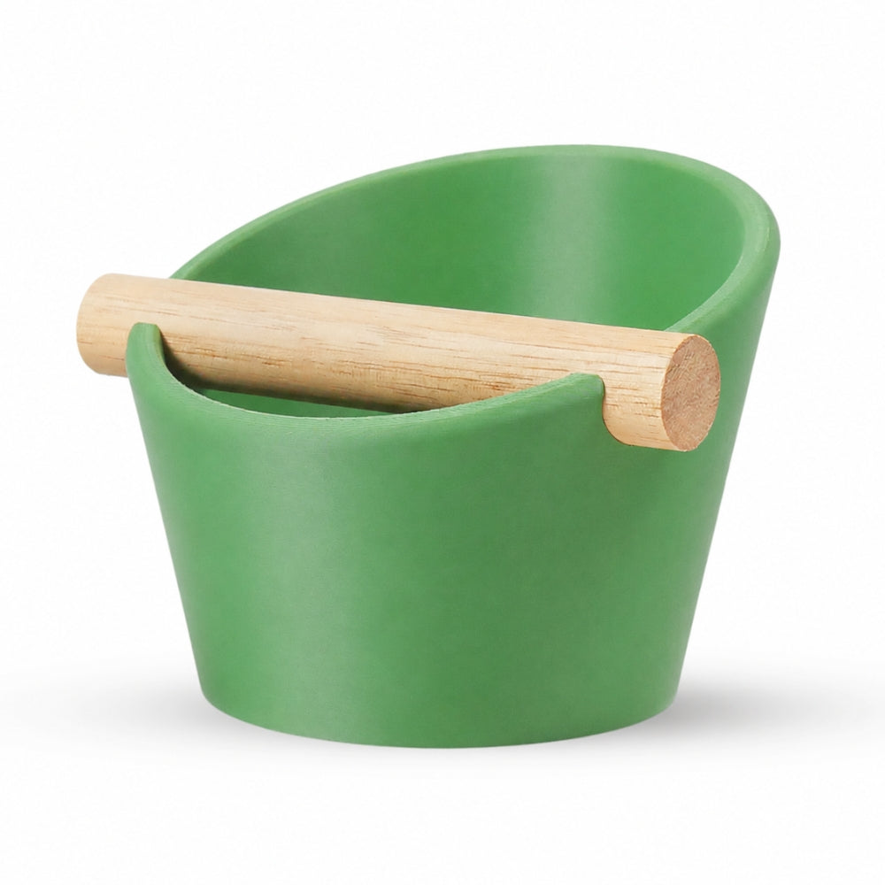 Oval coffee knock box with grass green finish and real oak wood bar by KNOCDIC®, used for espresso puck disposal.