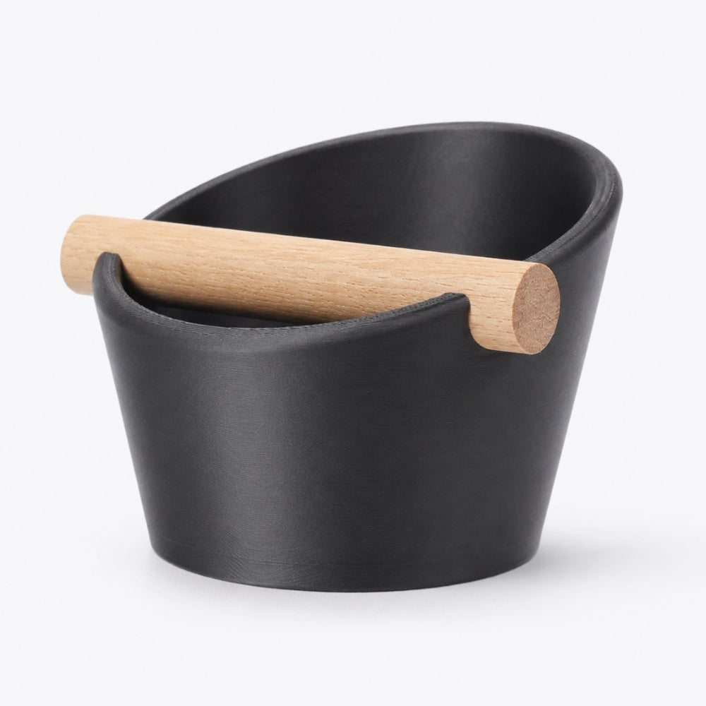KNOCDIC® oval coffee knock box with metallic black finish and real oak wood bar for espresso machine use.