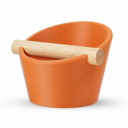 KNOCDIC® oval coffee knock box with a real oak wood bar for espresso puck disposal, featuring an orange exterior and durable design.