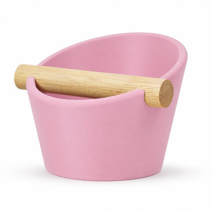 Pink oval coffee knock box with a real oak wood bar, made by KNOCDIC® for espresso machine cleaning.