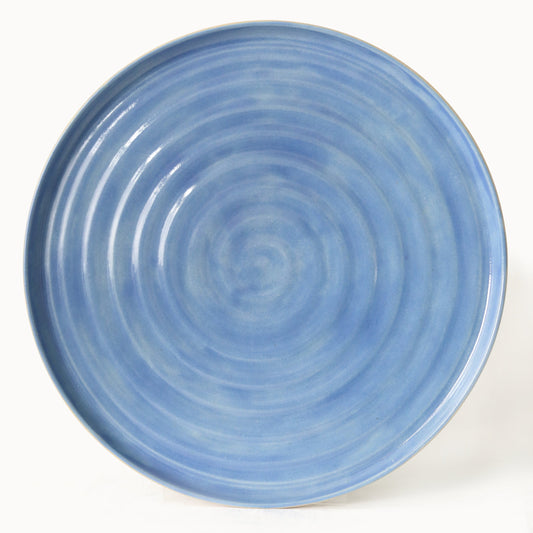 Pacific Blue Classic Dinner Plate by Katie L Thompson Designs, showcasing a round ceramic plate with vibrant blue glaze and subtle pattern.