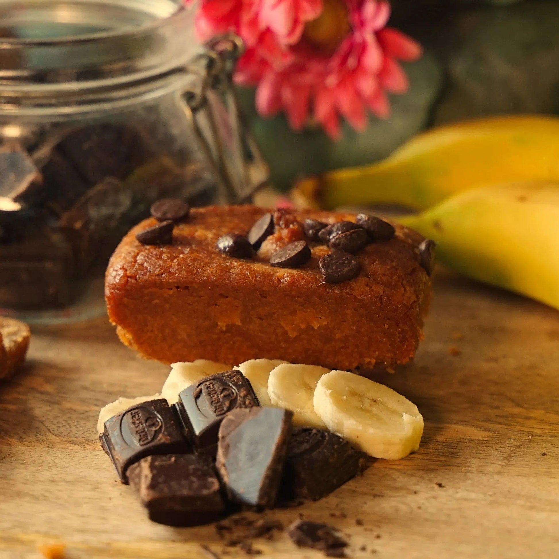 Vegan peanut butter, banana, and chocolate blondie brownie from The Healthy Cake Company, showing a close-up of the baked treat.