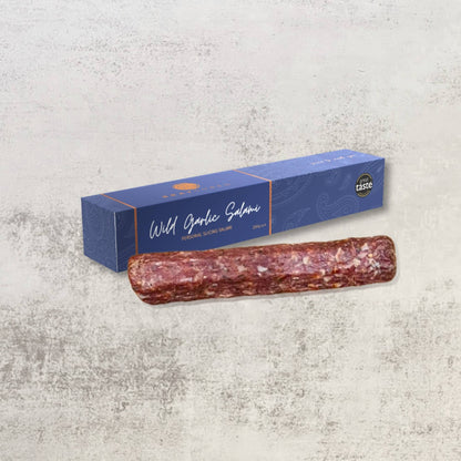 Thinly sliced Bray Cured Personal Slicing Salami on a wooden board, showcasing its marbled texture and rich flavor for charcuterie.