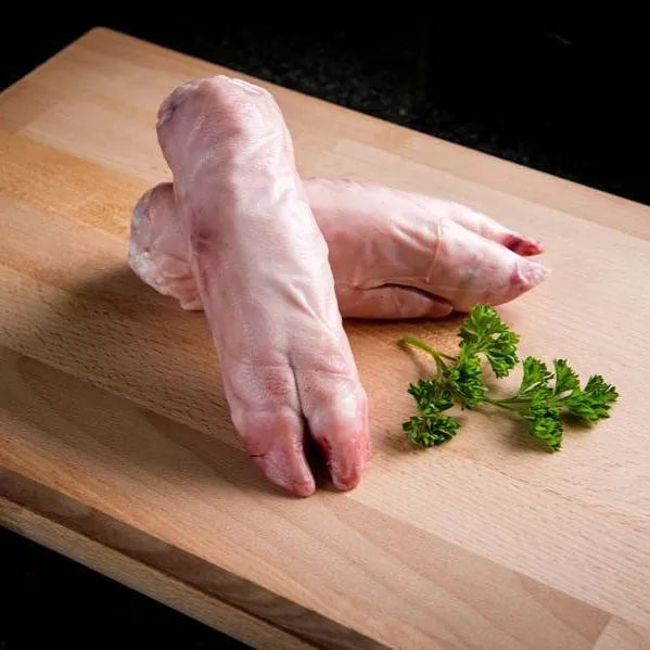 Fresh pig's trotters from Primrose Herd, showcasing clean, well-prepared pig's trotters on a white background.