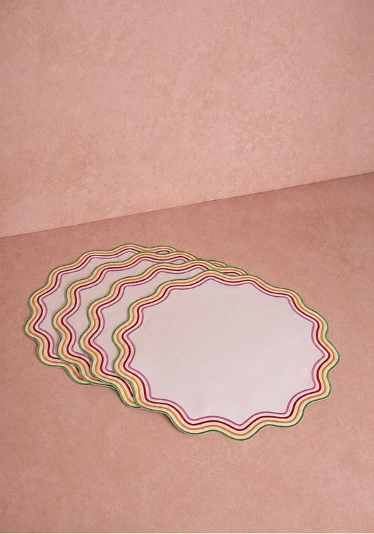 Set of four Casa by Josephine Jenno Alice multi-colored trim placemats with vibrant patterns on woven fabric.