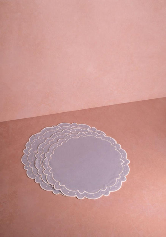 Set of four light blue Aurora placemats by Casa Josephine Jenno, featuring a smooth fabric surface and elegant design.