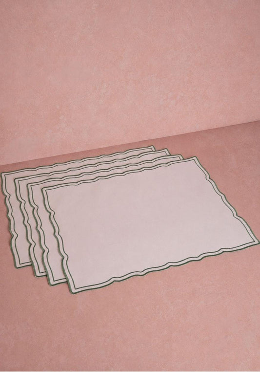 Set of four green rectangular placemats with wavy trim from Casa by Josephine Jenno, perfect for table setting decor.