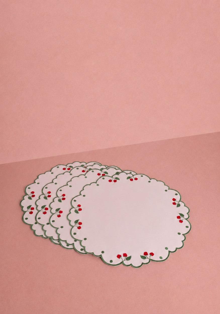 Set of four Ripe Cherry round placemats by Casa by Josephine Jenno, featuring vibrant cherry pattern for dining table decor.