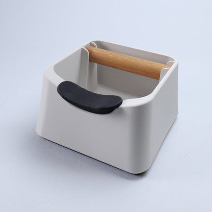 KNOCDIC® The Pod coffee knock box with black rubber exterior and metal bar for disposing used coffee grounds.