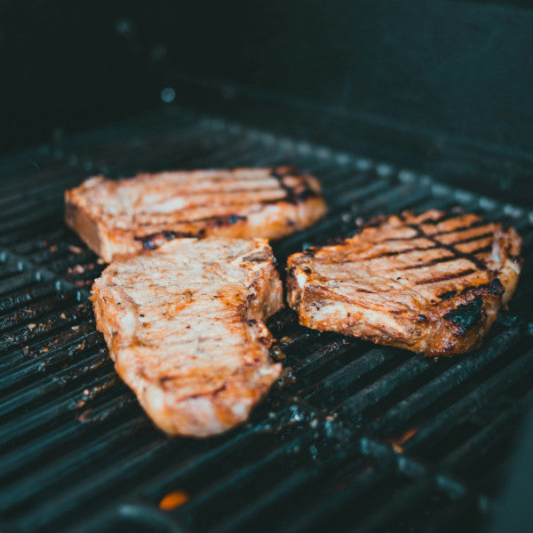 Close-up of GOODNESS IN A BOWL Pork Rub container with the seasoning, showing the textured, flavorful spice blend for grilling or barbecue.