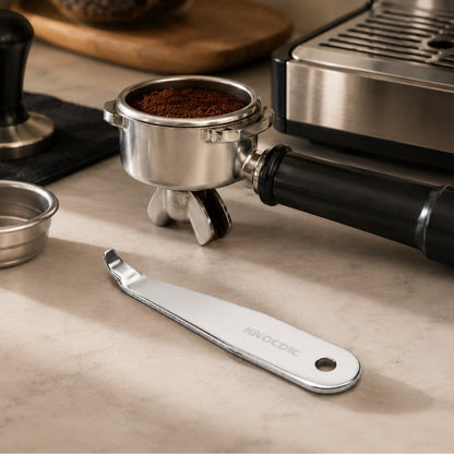 KNOCDIC® portafilter basket lifter tool used for removing and handling coffee portafilter baskets in a barista setting.