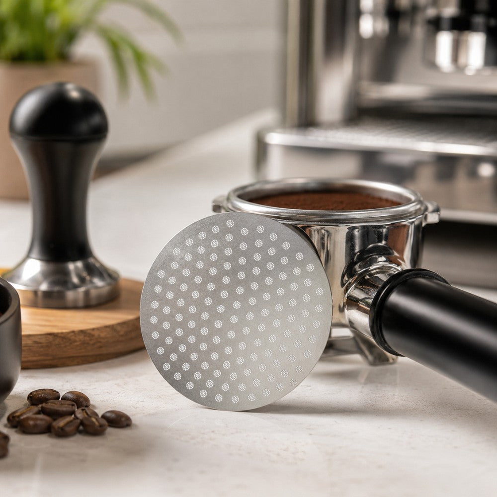 KNOCDIC® espresso puck screen in use inside a portafilter basket for even coffee extraction.