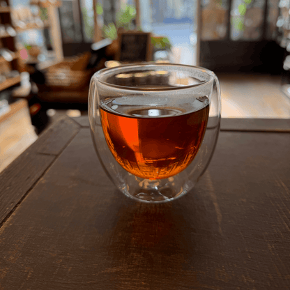 Black Pumpkin Spice Tea by Porter Hill Tea Company, brewed in a cup with visible pumpkin spice aroma and rich dark tea leaves.