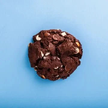 Cool Hog Snacks quadruple chocolate cookie showing a rich, gooey chocolate cookie with four types of chocolate chunks and a crispy texture.