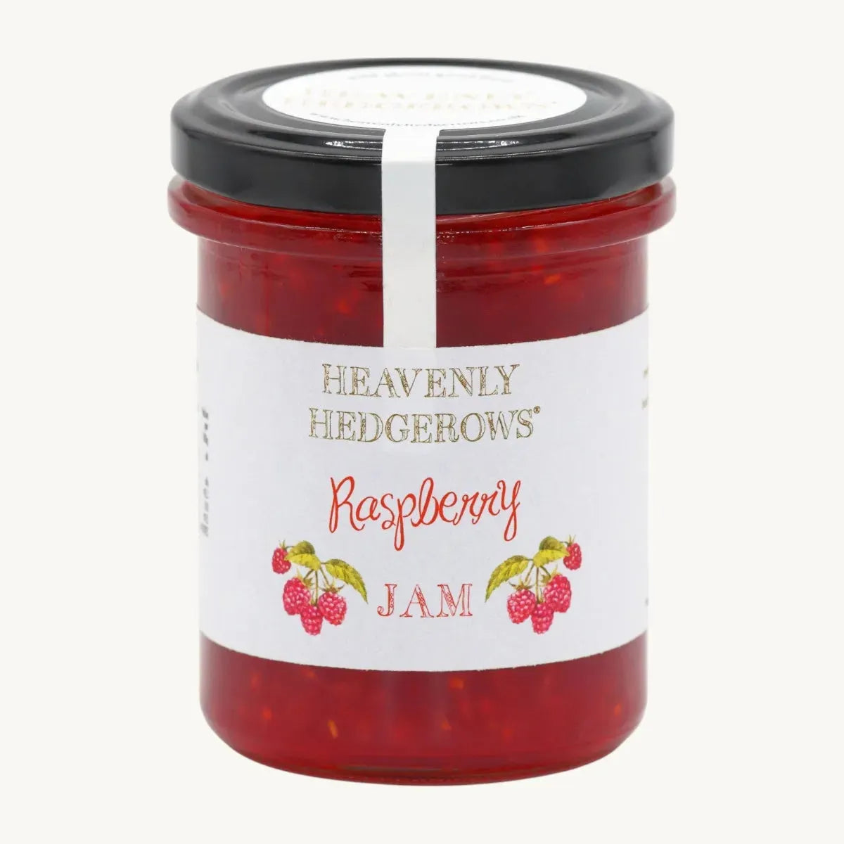 Jar of Heavenly Hedgerows raspberry jam with fresh raspberries and a rustic wooden background.