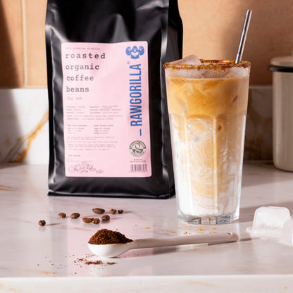 Roasted organic whole coffee beans from RawGorilla, 1kg package, showing glossy, roasted coffee beans.