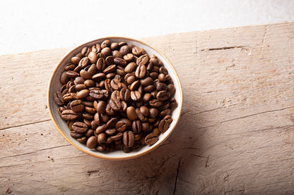 Organic roasted whole coffee beans from RawGorilla, shown in a 1kg bag, with rich brown beans ready for grinding.