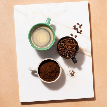 Roasted organic whole coffee beans in a 1kg bag from RawGorilla, featuring glossy brown beans with a rich aroma.