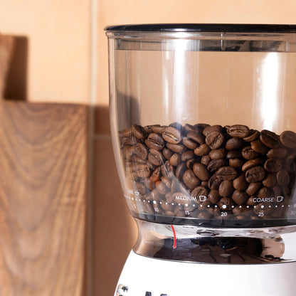 Roasted organic whole coffee beans by RawGorilla, 1kg, from Whole Food Earth, showing dark roasted coffee beans in a clear container.