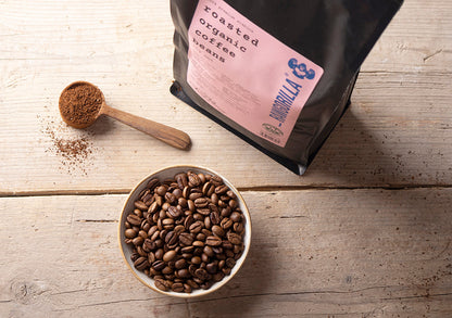 Roasted organic whole coffee beans from RawGorilla, 1kg, showcasing glossy brown beans ready for brewing.