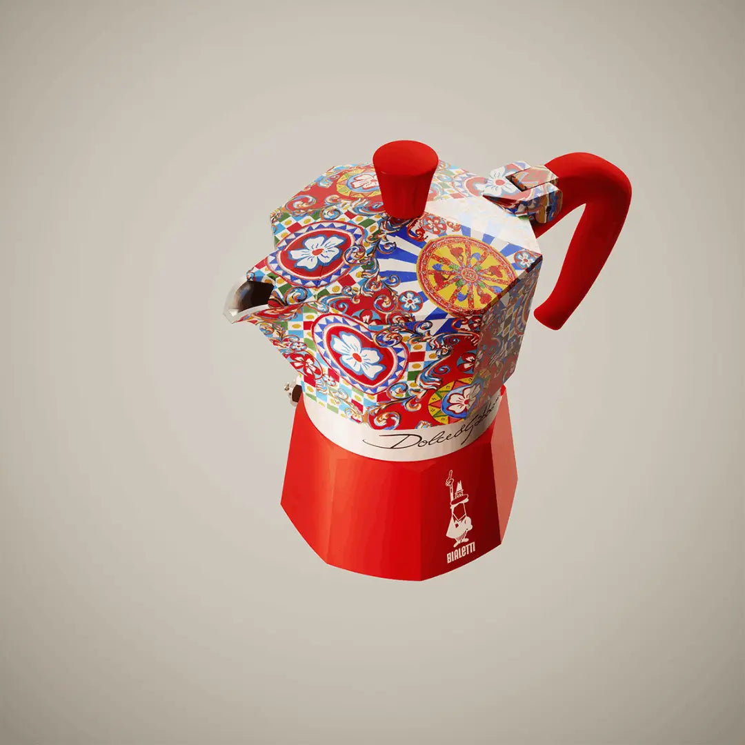 Red Bialetti Moka Express coffee maker featuring Dolce & Gabbana Sicilian Cart design, crafted by Brew Italia.