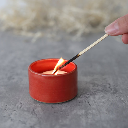 Cherry red tea light holder by Katie L Thompson Designs featuring a square shape and a warm, inviting glow.