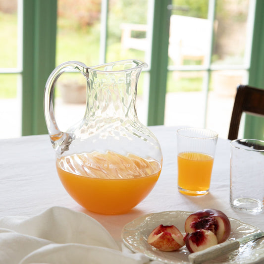 Large crystal water jug with a ripple design by The Vintage List, showcasing elegant craftsmanship and a textured surface.