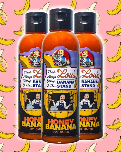 Bottle of Lou's Brews There's Always Honey In The Banana Stand banana and honey sauce, a sweet condiment in a clear glass bottle.