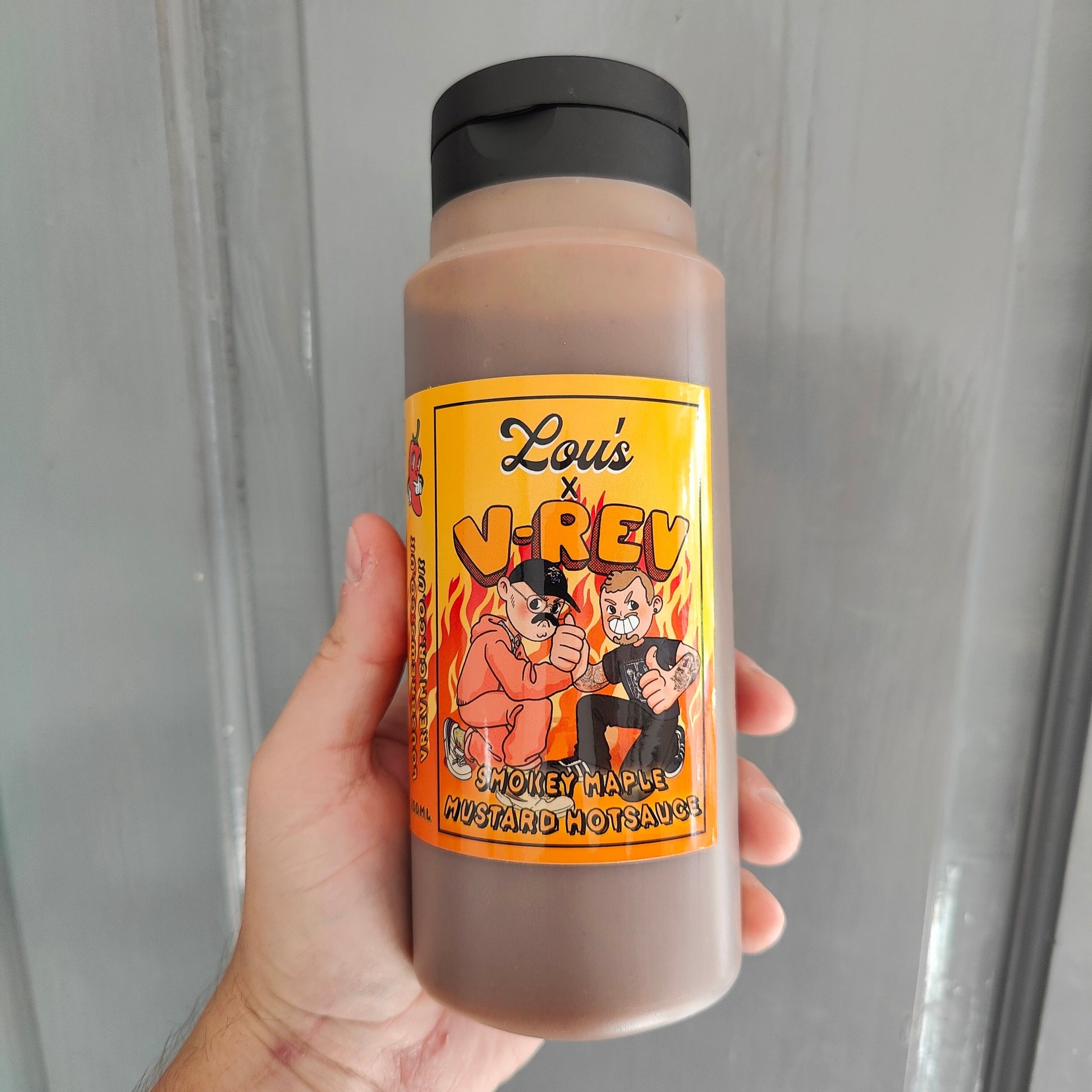 Lou's x V-Rev Smoky Maple Mustard Hot Sauce bottle with label, showcasing rich, smoky mustard flavor in a glass bottle.