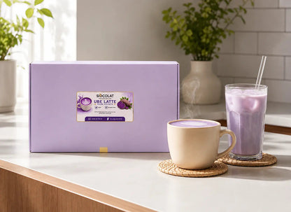 Vegan purple yam instant latte sachets by Siocolat, sugar-free and purple in color, with a cup of prepared Ube Latte drink.