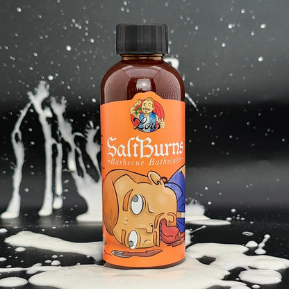 Bottle of Saltburns Barbecue Bathwater hot sauce by Lou's Brews, featuring a label with bold text and vibrant colors.