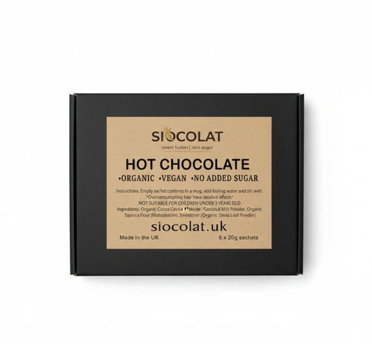 Siocolat Organic Vegan Sugar-Free Low Calorie Hot Chocolate Drink in a mug with a spoon, topped with whipped cream and cocoa powder.