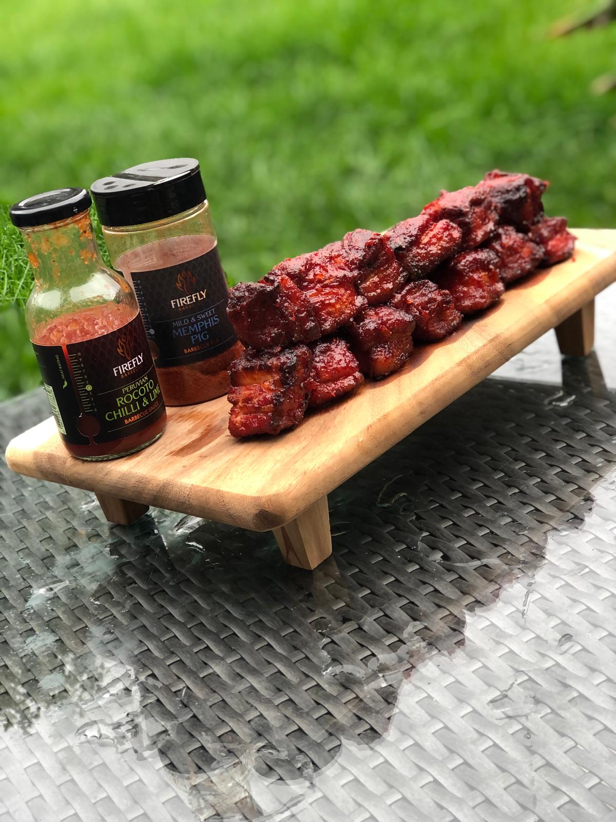 Peruvian Rocoto sweet chili and lime sauce in a jar, spicy BBQ sauce from FireFly Barbecue with vibrant red chili peppers and lime slices