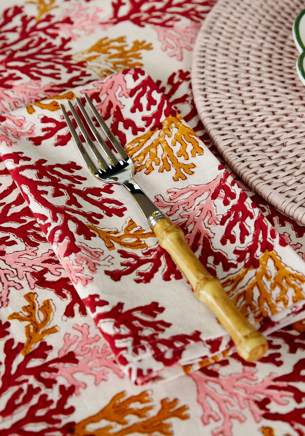 Set of four Rose Coral table napkins by Casa by Josephine Jenno, soft fabric with vibrant coral and rose pink tones.