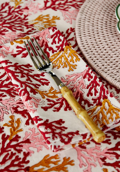 Set of four Rose Coral table napkins by Casa by Josephine Jenno, soft fabric with vibrant coral and rose pink tones.