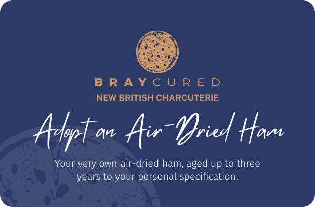 Bray Cured air-dried ham gift card for charcuterie experience, displayed alongside slices of salami on a white background.