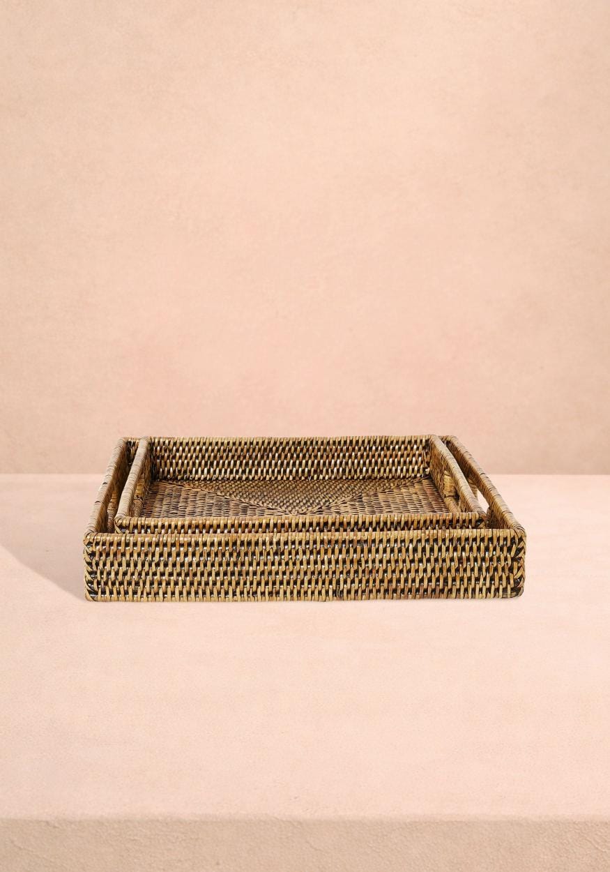 Pair of square rattan serving trays in classic brown from Casa by Josephine Jenno, perfect for serving or decorative use.