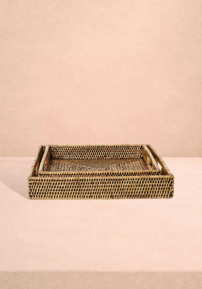 Pair of square rattan serving trays in classic brown from Casa by Josephine Jenno, perfect for serving or decorative use.