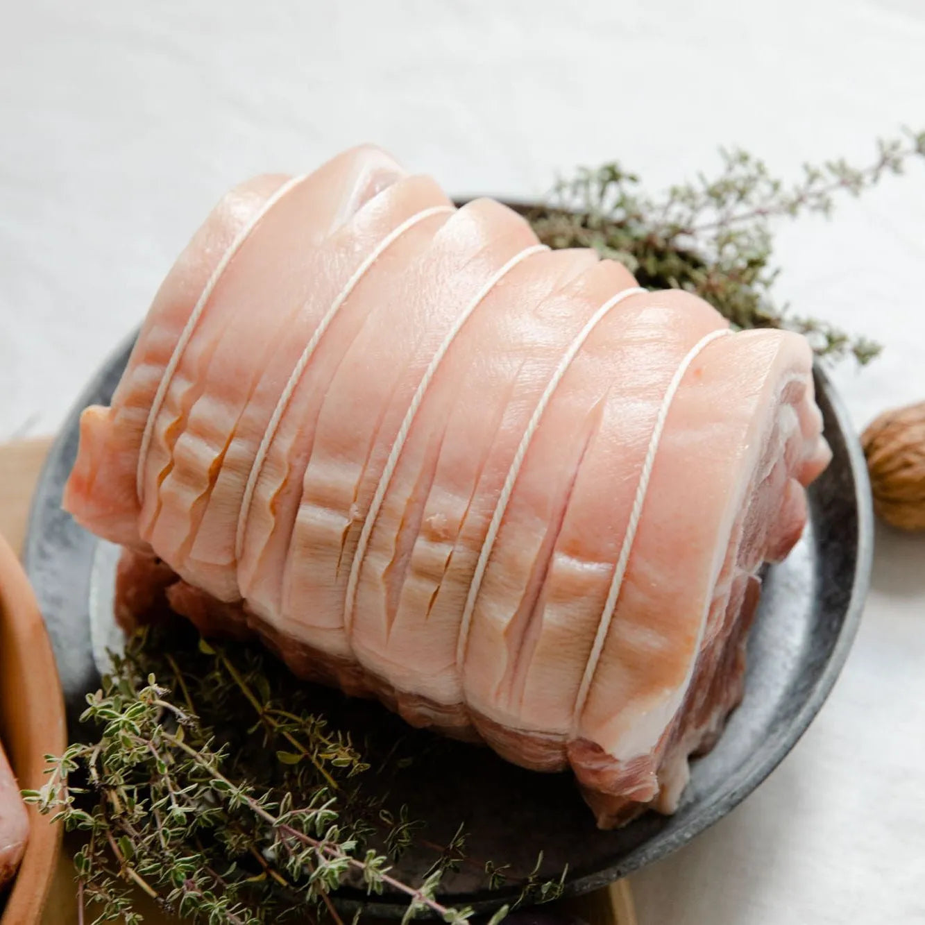 Fresh pork shoulder joint from Primrose Herd, showcasing the well-marbled pork shoulder ready for roasting or slow cooking.