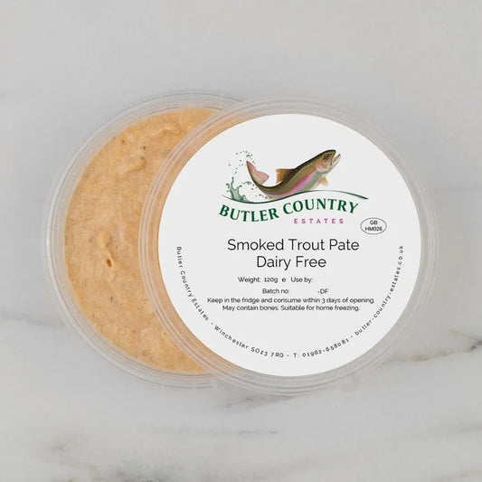 Creamy dairy-free smoked trout pate by Butler Country Estates, served in a bowl with fresh herbs and lemon slices.