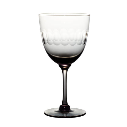 four smoky crystal wine glasses with lens design