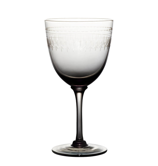 Four smoky crystal wine glasses with oval design by The Vintage List, showcasing elegant, rounded glassware for wine presentation.