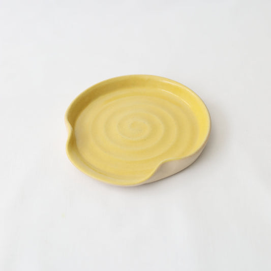 Sun yellow ceramic spoon rest by Katie L Thompson Designs, with a classic shape and smooth finish for kitchen use.