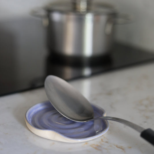 Amethyst purple ceramic spoon rest from Katie L Thompson Designs, with a classic round shape and smooth finish for kitchen use.